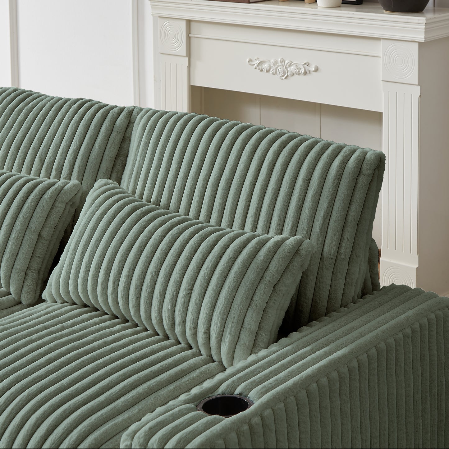 Sage green corduroy sofa with plush cushions