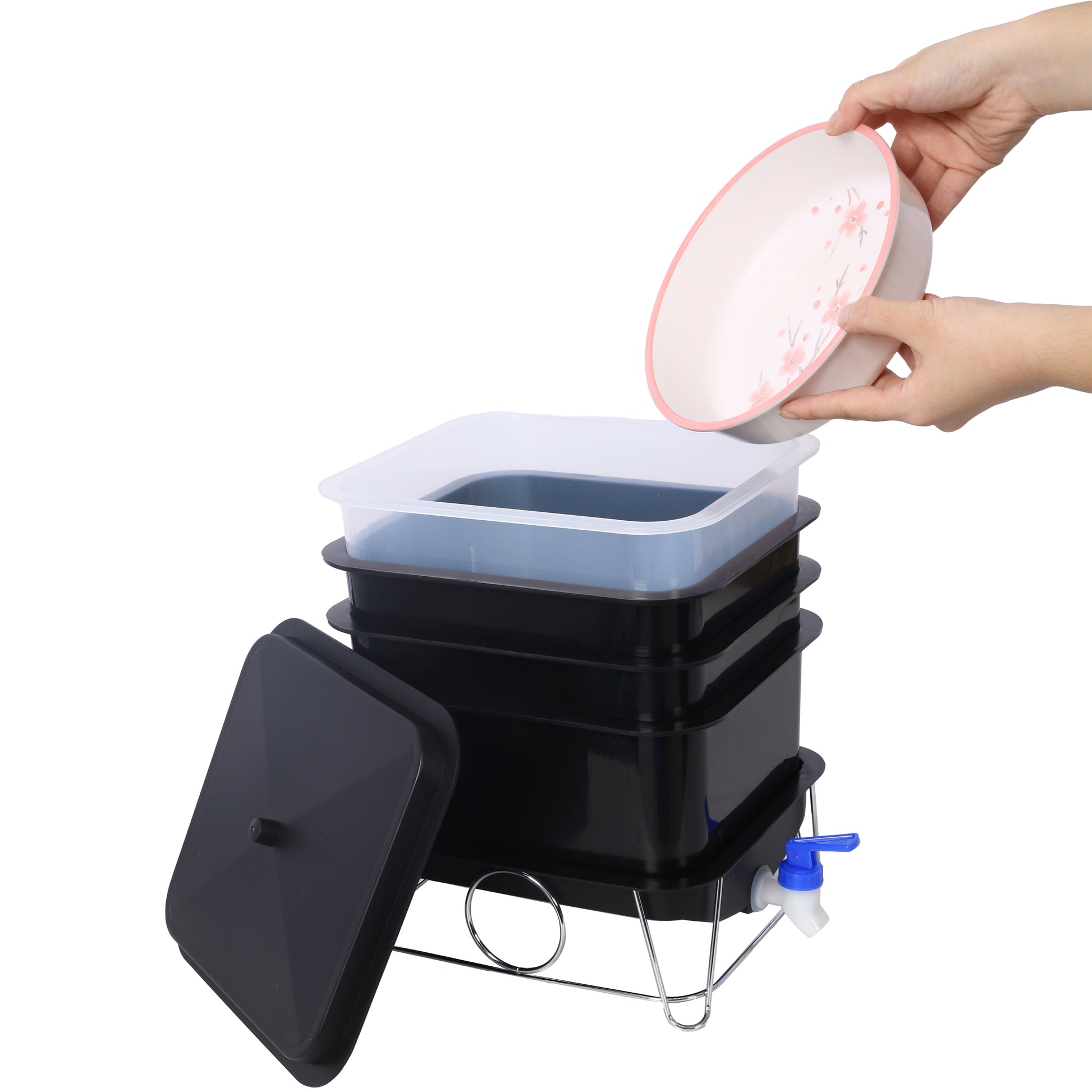 Black multitier composting bin with a clear lid and blue spigot