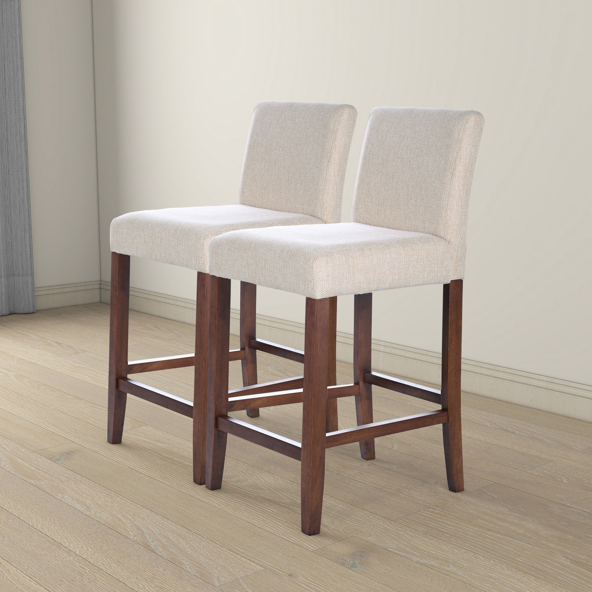 Two upholstered bar stools with cream fabric seats and dark wood legs