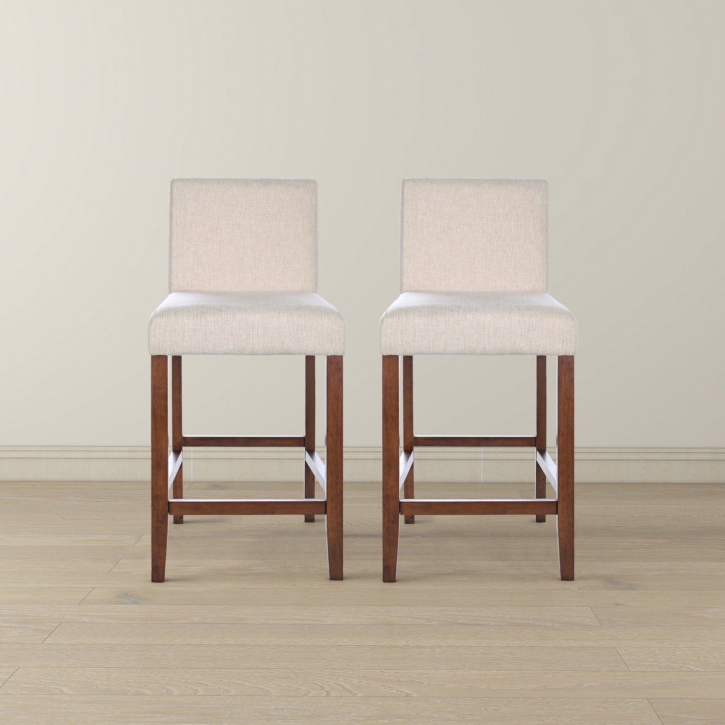 Two upholstered beige bar stools with dark wood legs