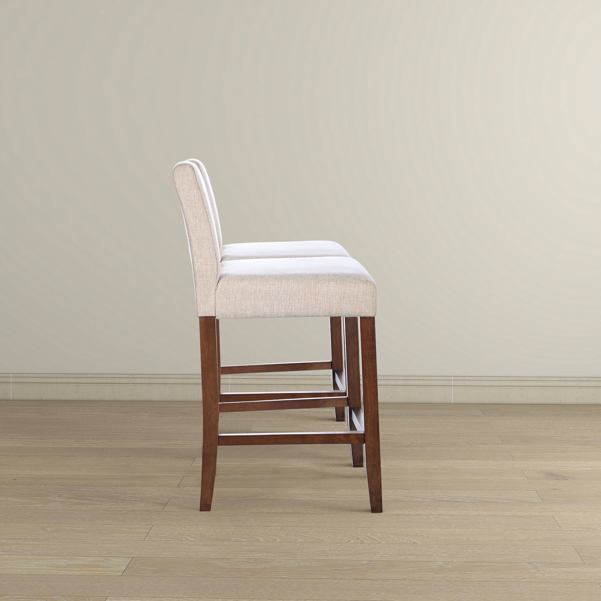 Two cream fabric bar stools with dark wood legs