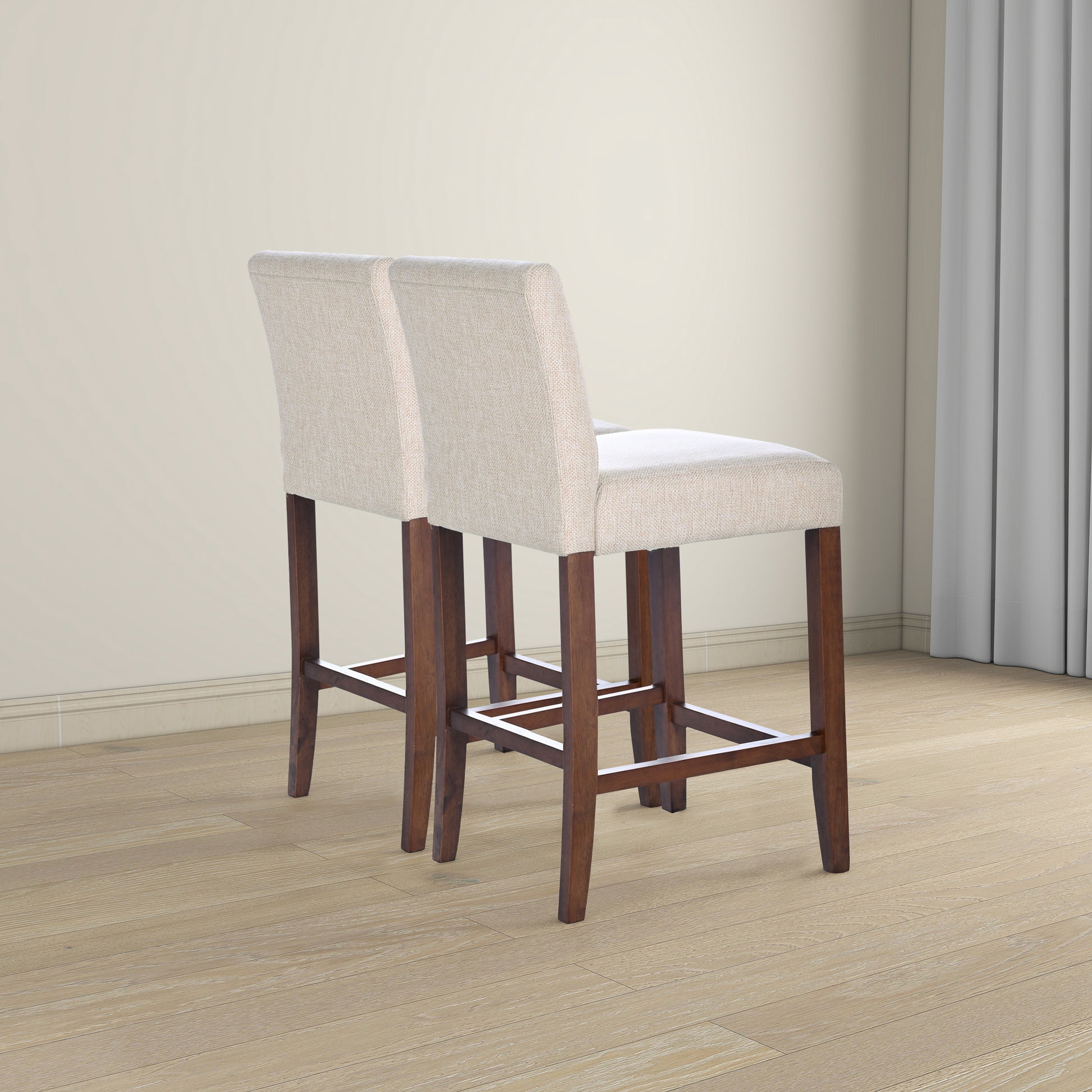 Two beige upholstered bar stools with dark wood legs