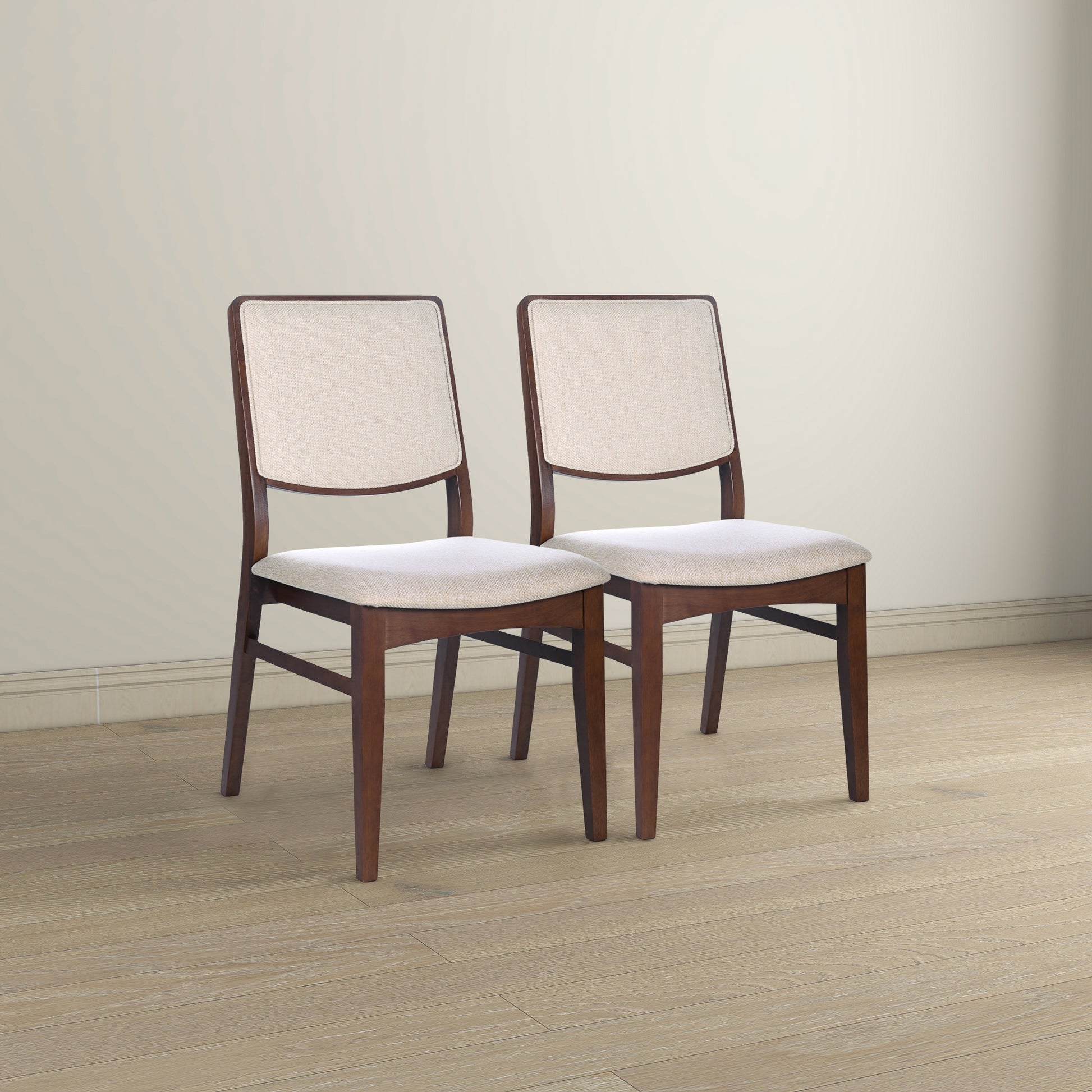 Two upholstered dining chairs with dark wood frames and light beige fabric seats and backs
