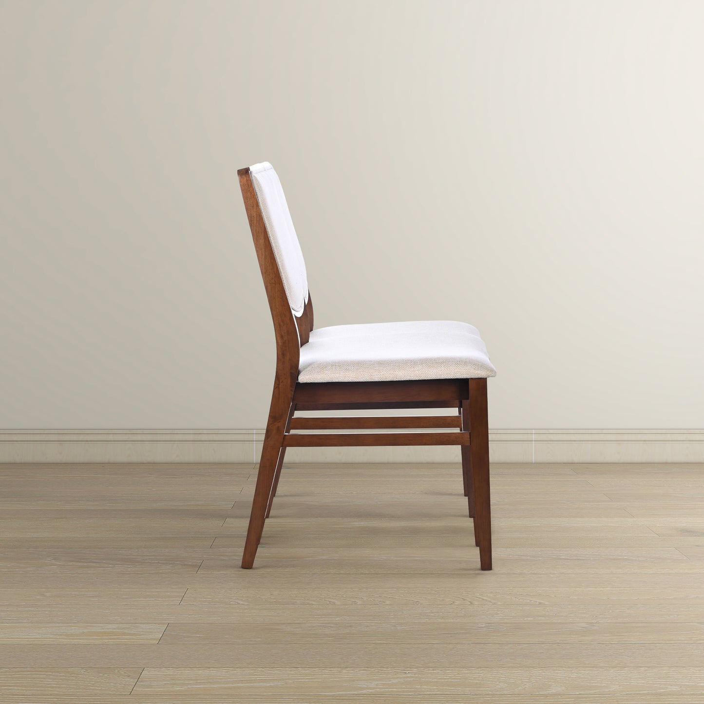 Side profile of a modern dark wood dining chair with a light beige upholstered seat and back