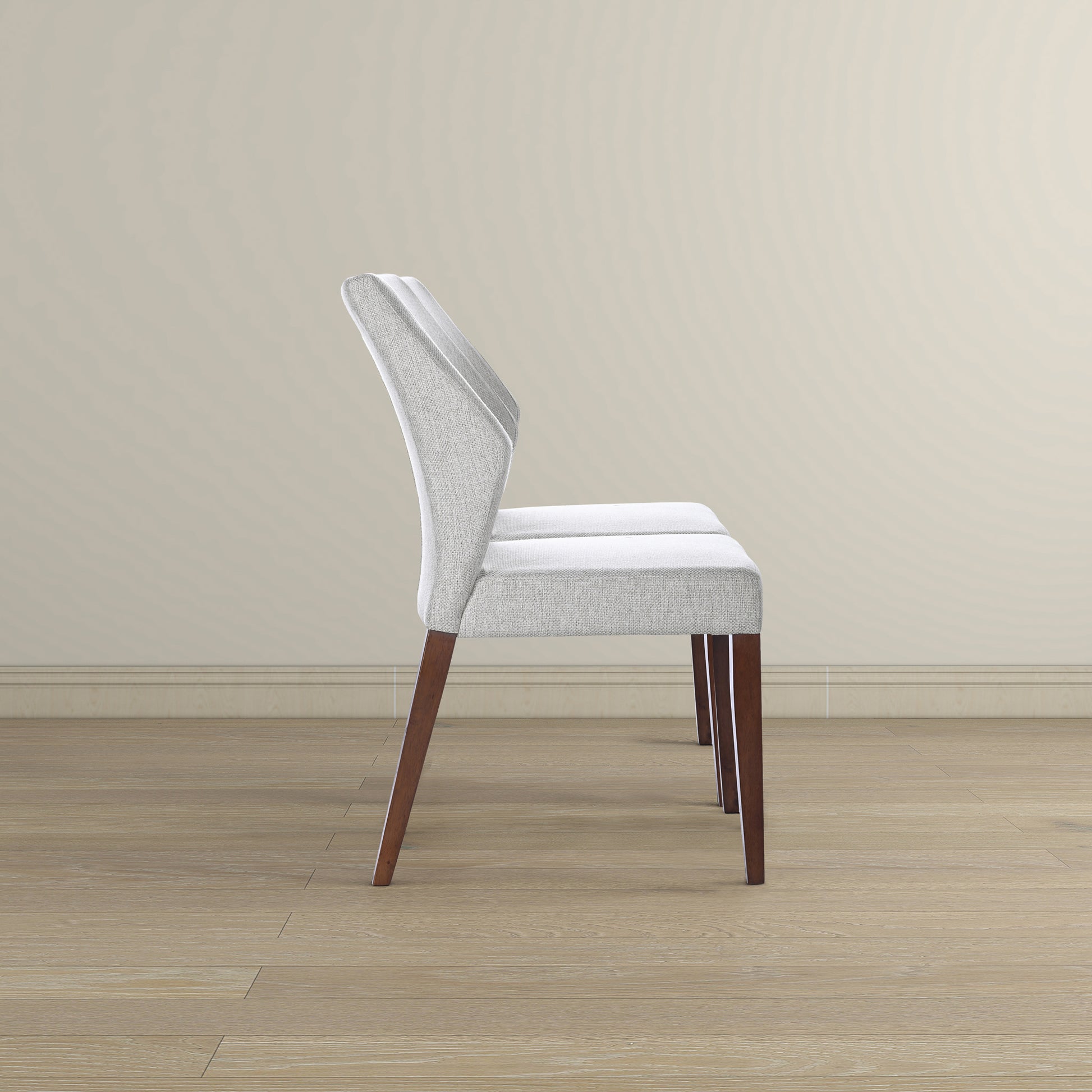 Light grey upholstered dining chair with angled wooden legs