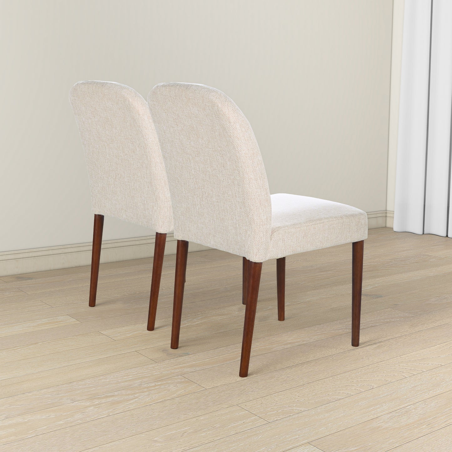 Set of two beige upholstered dining chairs with dark wood legs
