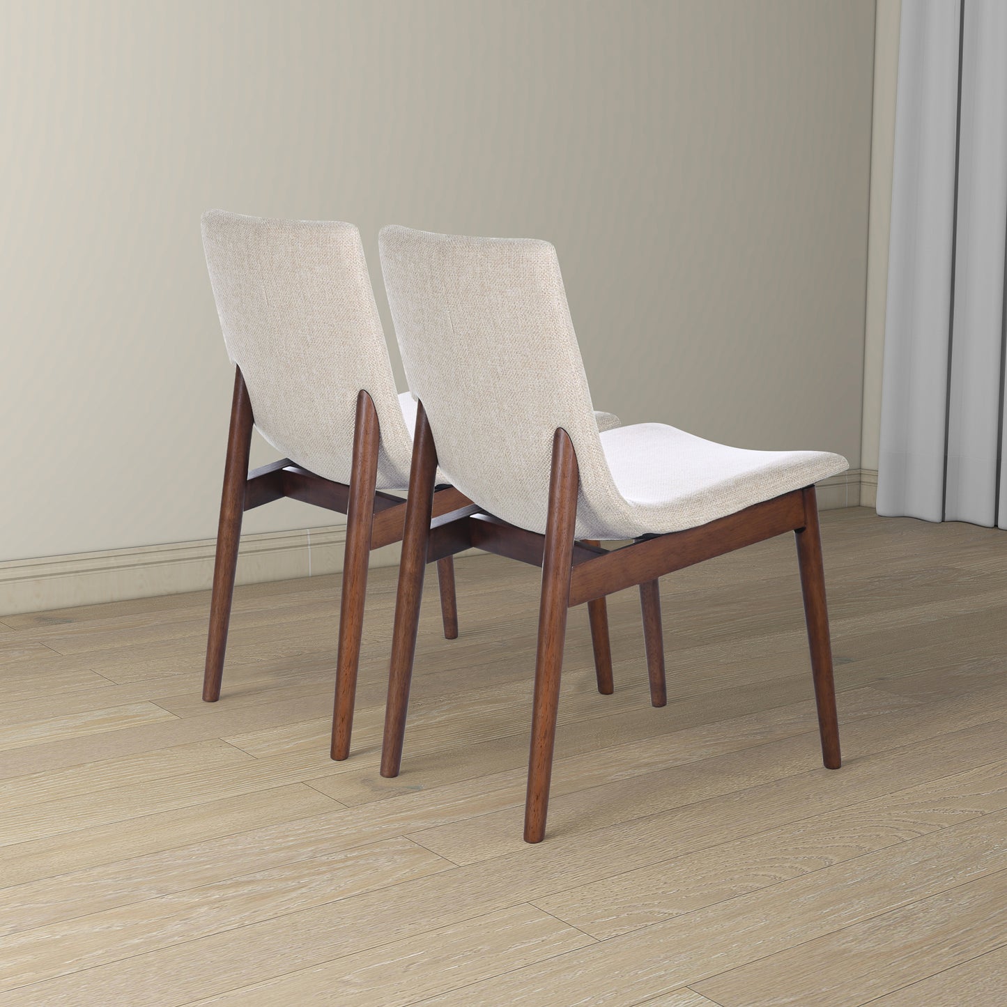 Two modern beige upholstered dining chairs with walnut wood legs