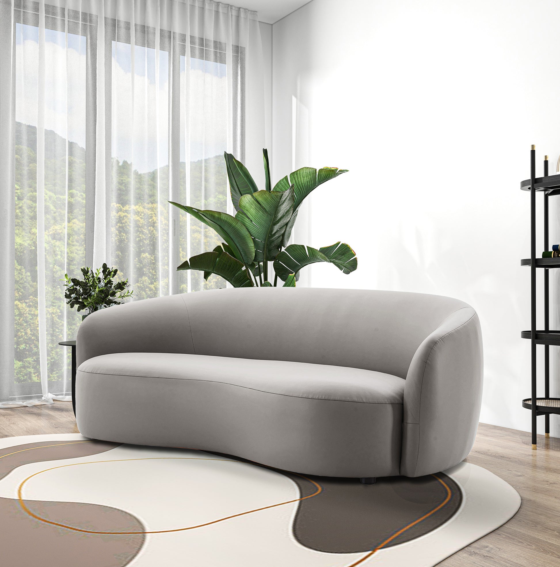 Curved light gray velvet sofa with organic modern design