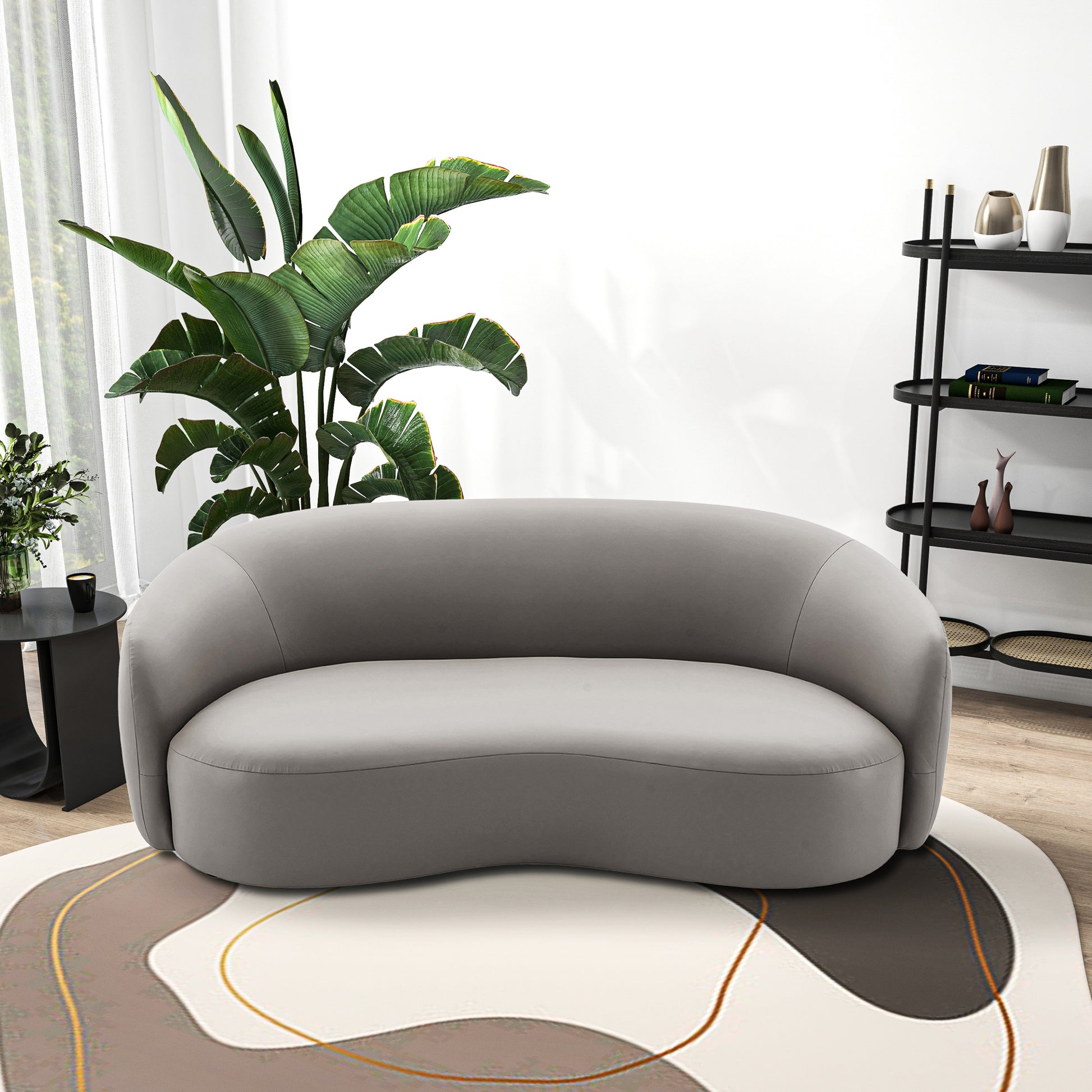 Curved gray velvet sofa with modern design and sleek lines