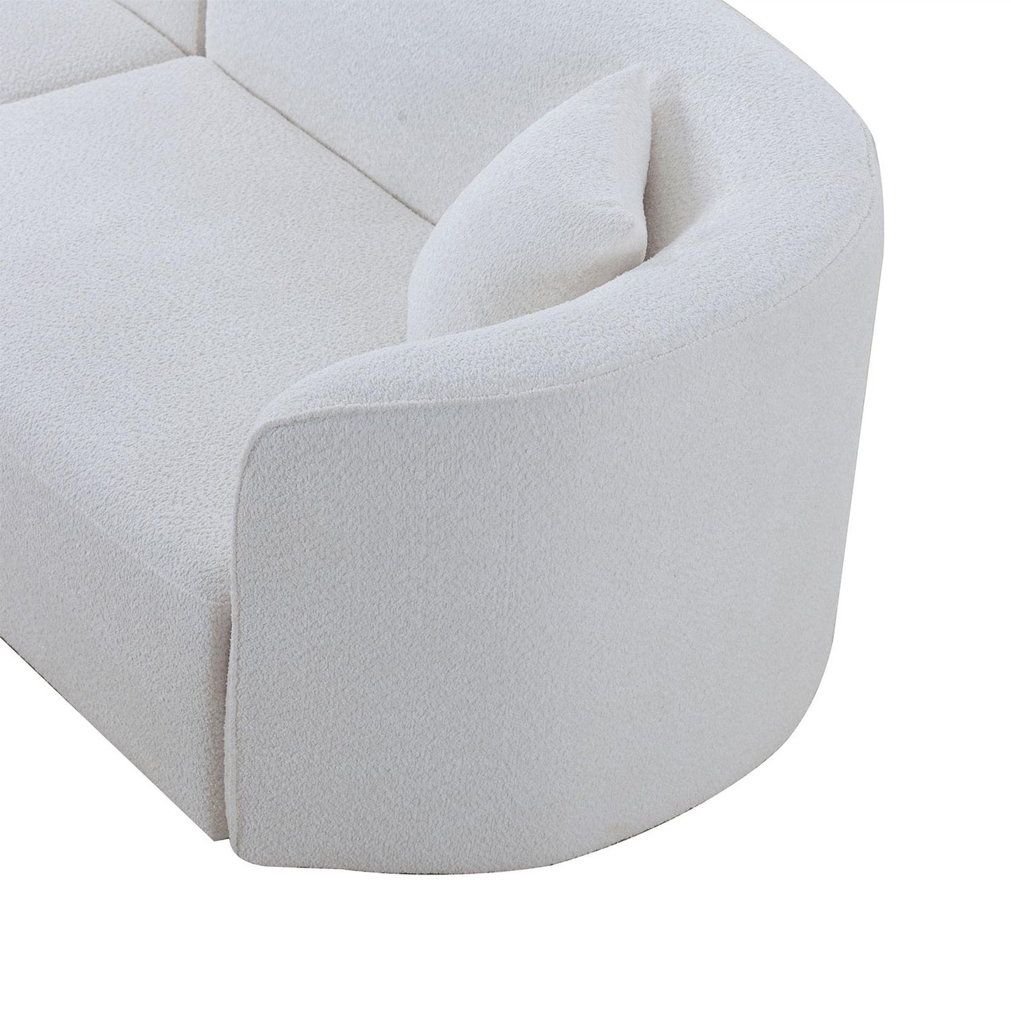 Closeup of plush white boucle sofa section with curved armrest