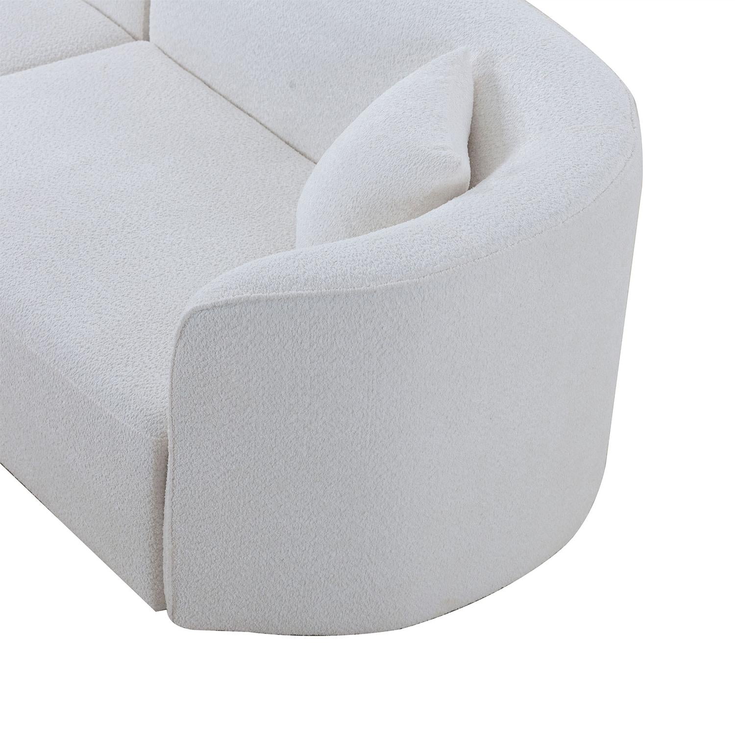 Closeup of plush white boucle sofa section with curved armrest