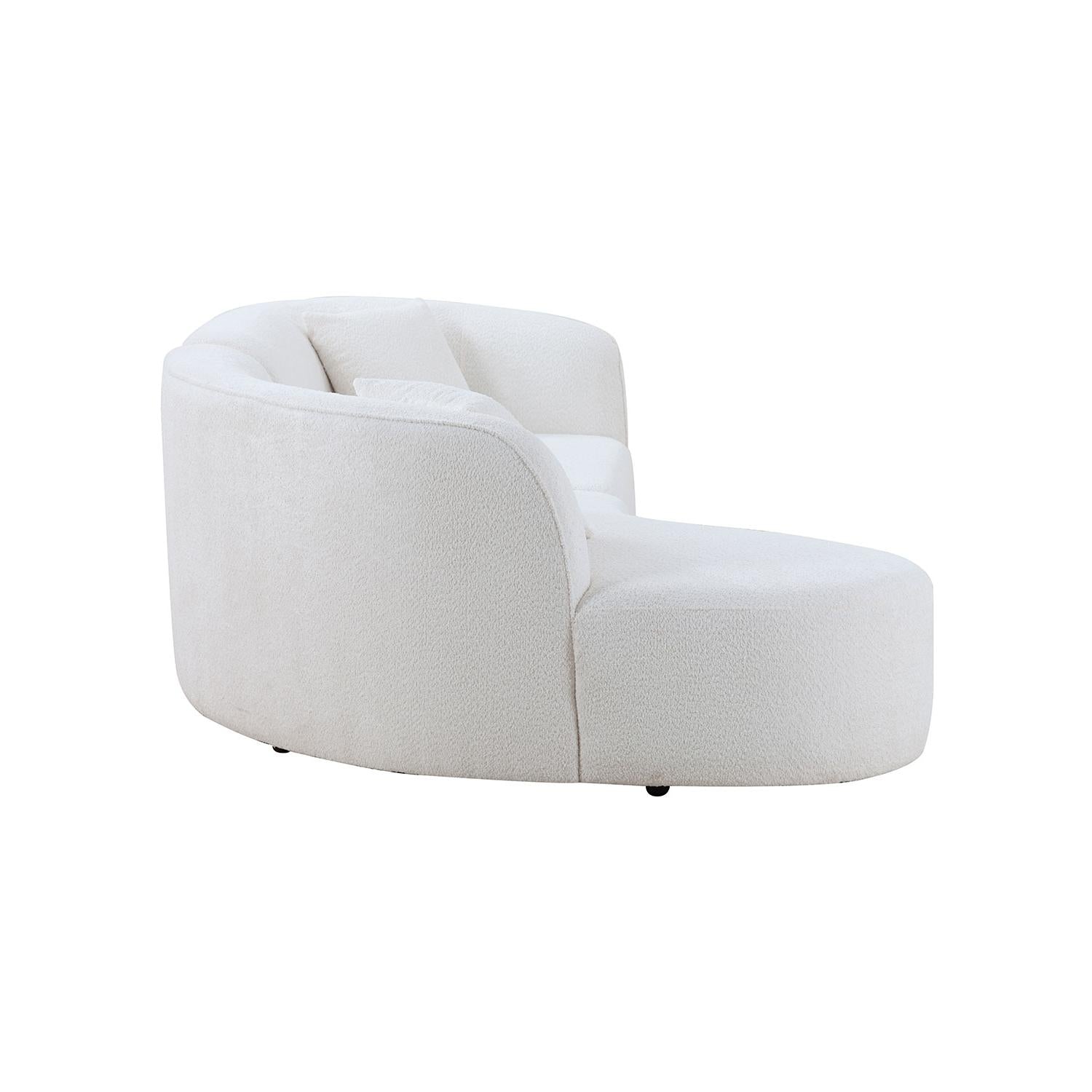 Curved cream boucle chaise lounge with plush pillows