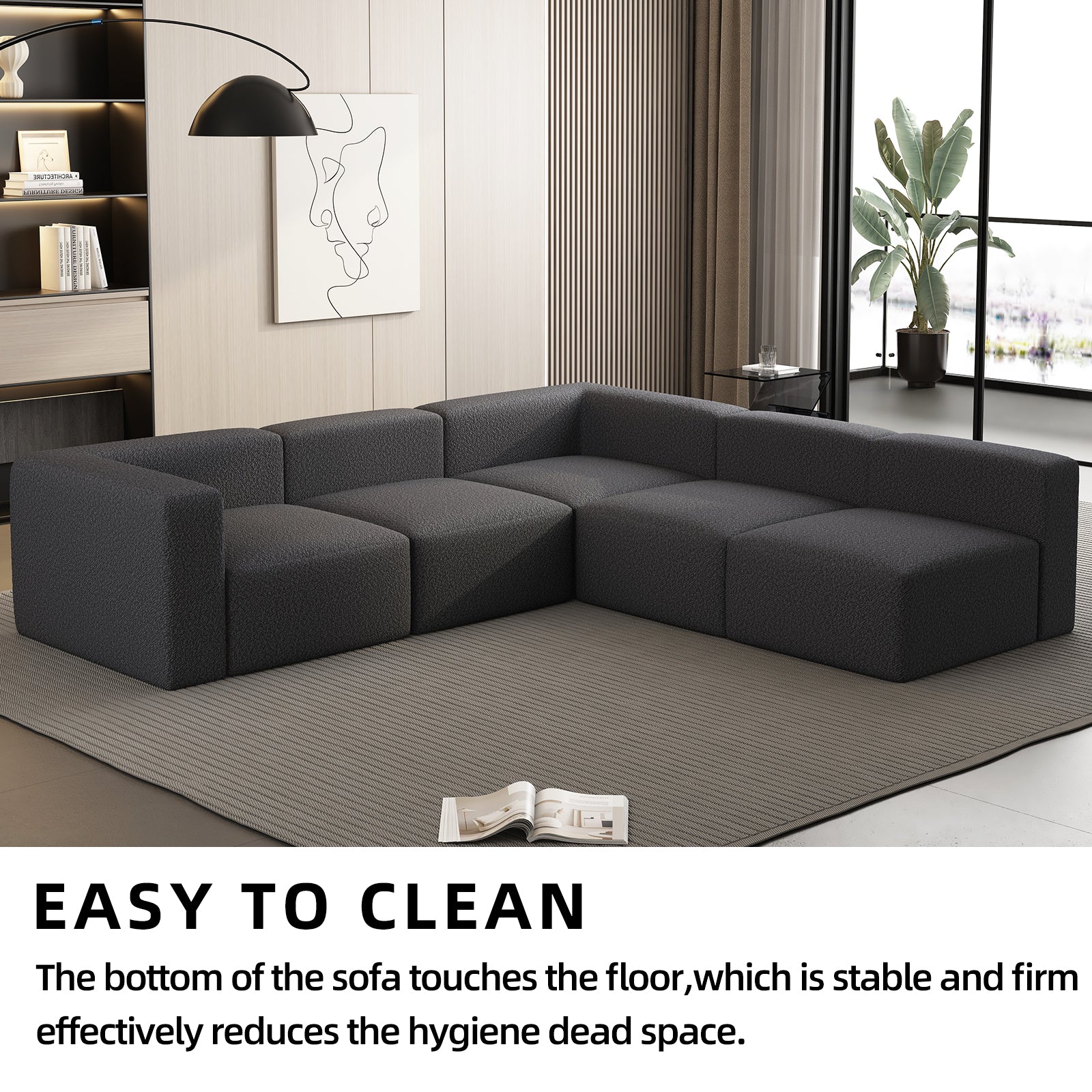Dark gray modular boucle sofa with plush cushions arranged in a sectional configuration
