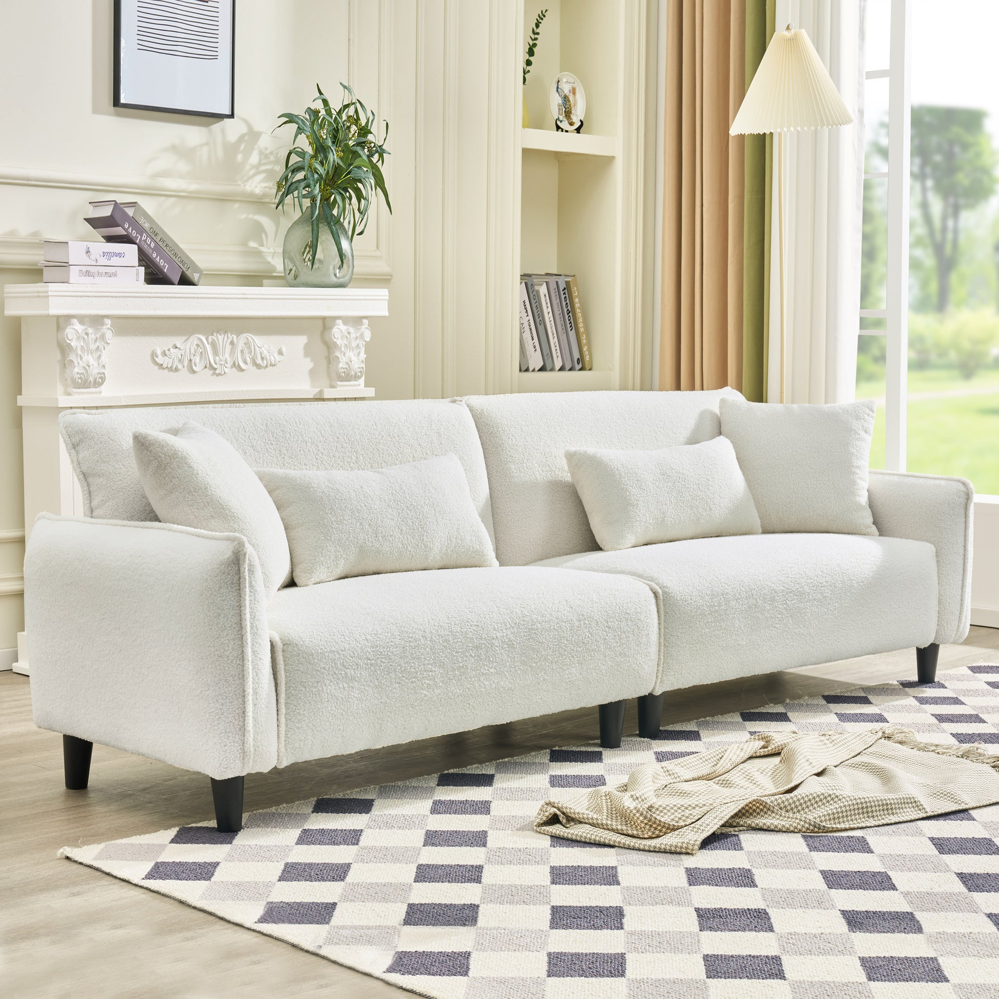 Plush white boucle sofa with accent pillows
