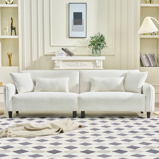 Plush white sofa with textured fabric and accent pillows