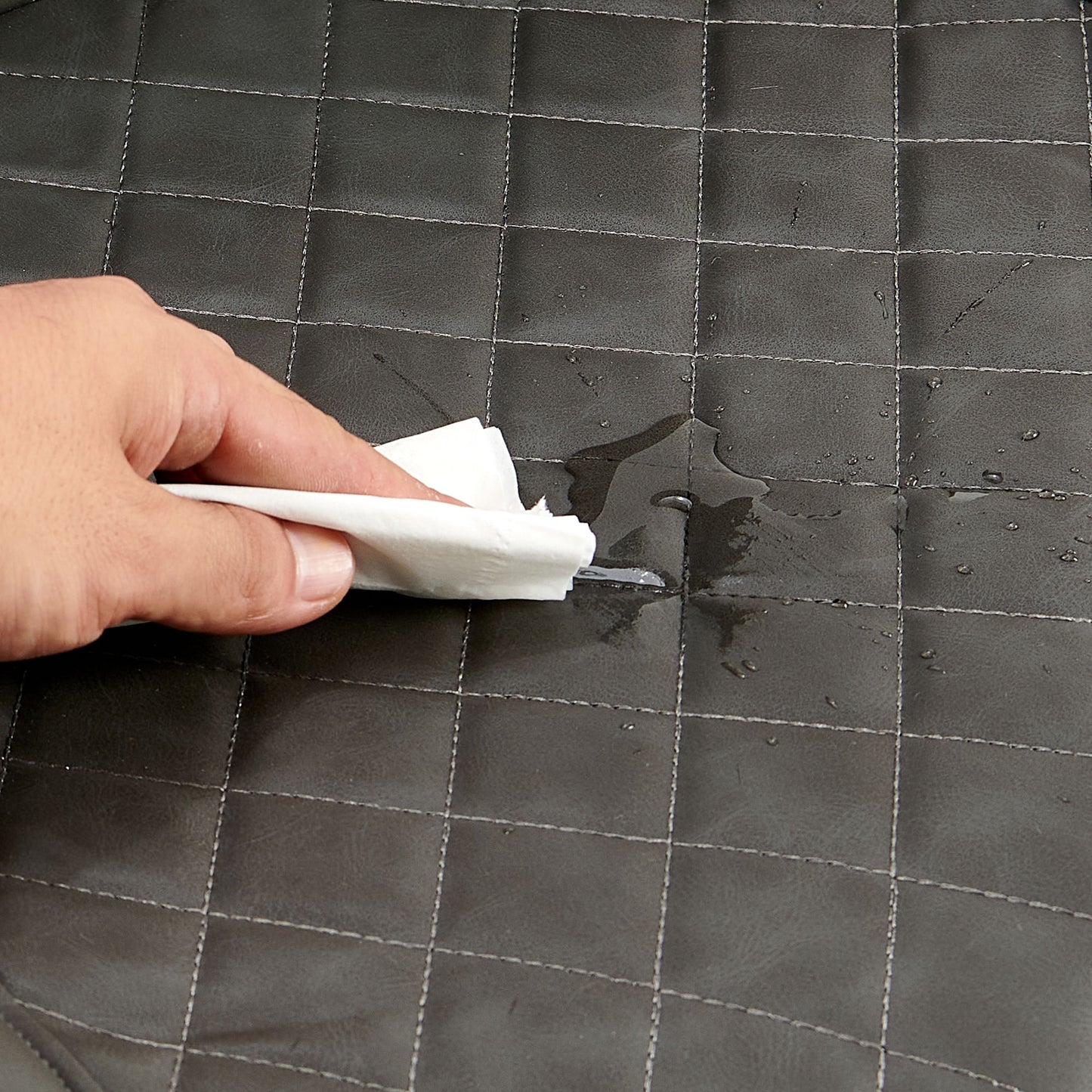 Dark gray quilted vinyl showing water beads after being wiped