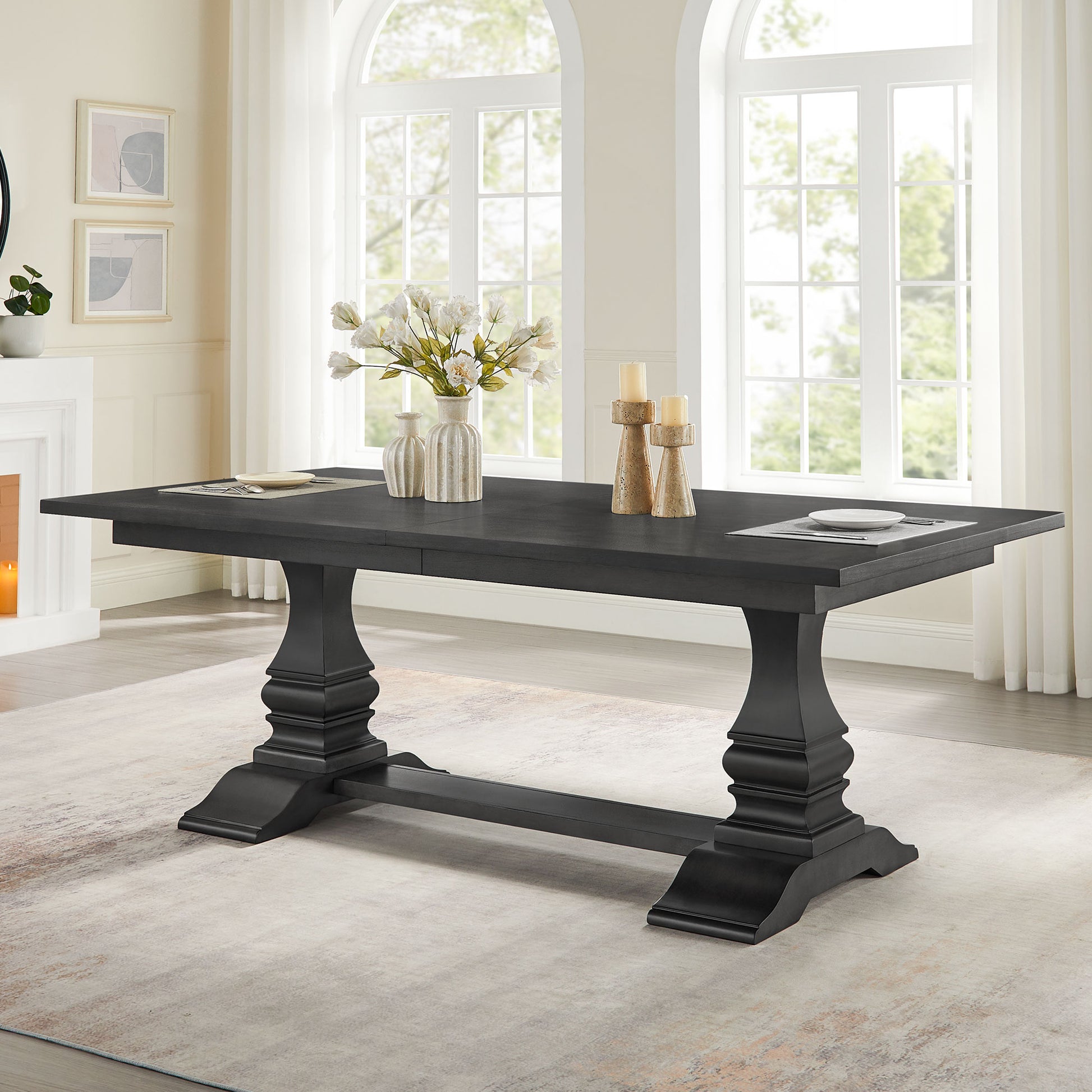 Dark gray pedestal dining table with ornate carved legs
