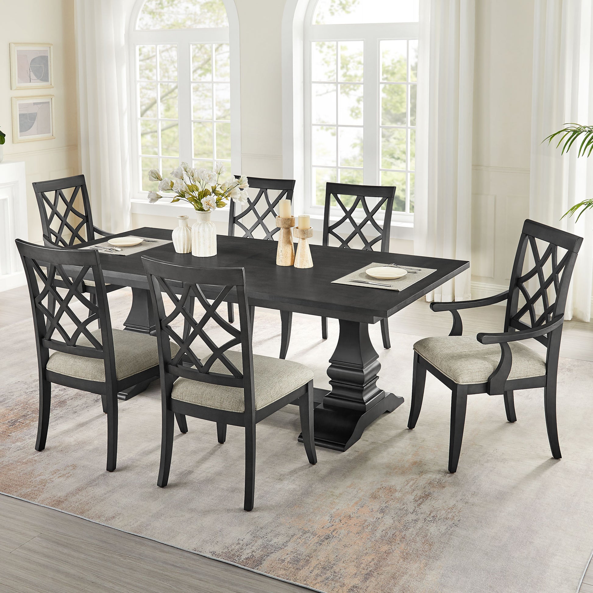 Dark wood dining table with pedestal base and six latticeback chairs