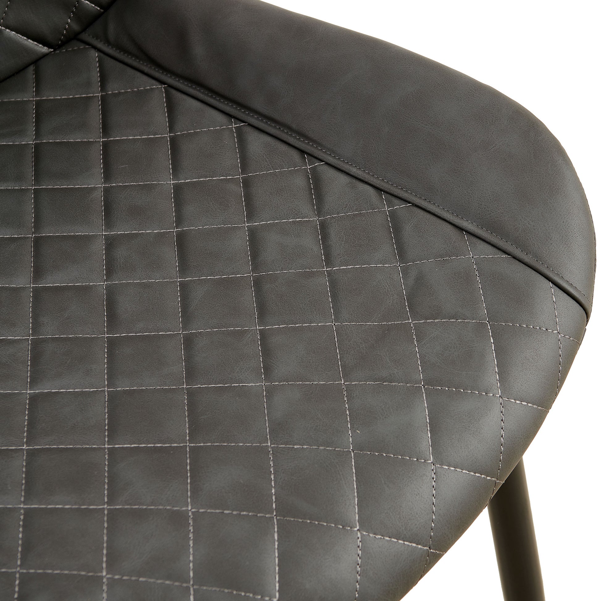 Closeup of charcoal grey vegan leather chair with diamond stitching