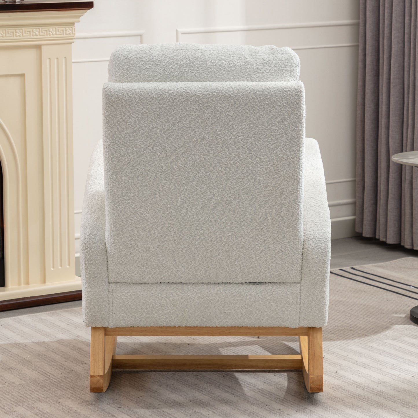 Light grey boucle armchair with wooden legs