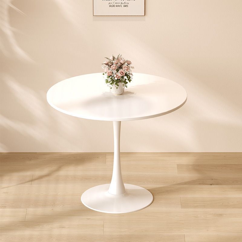 White round tulip dining table with floral centerpiece