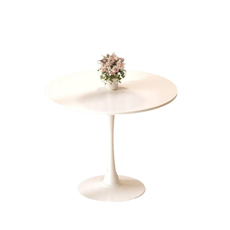 Round white pedestal dining table with flower centerpiece