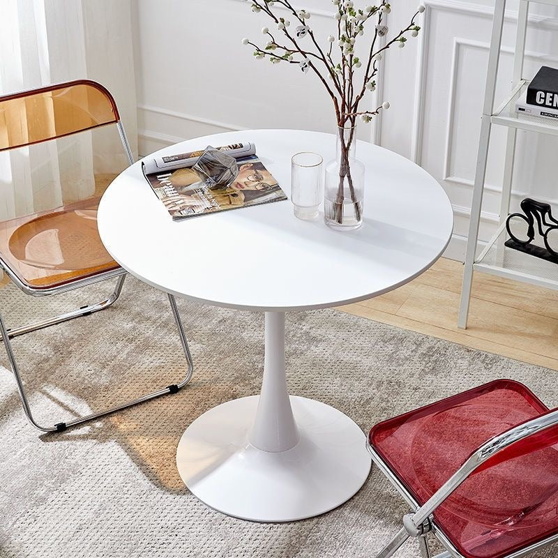 White round pedestal dining table with transparent amber chair