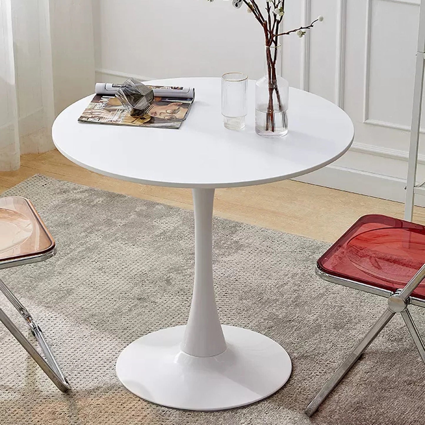 Modern white round dining table with a tulip base and minimalist design