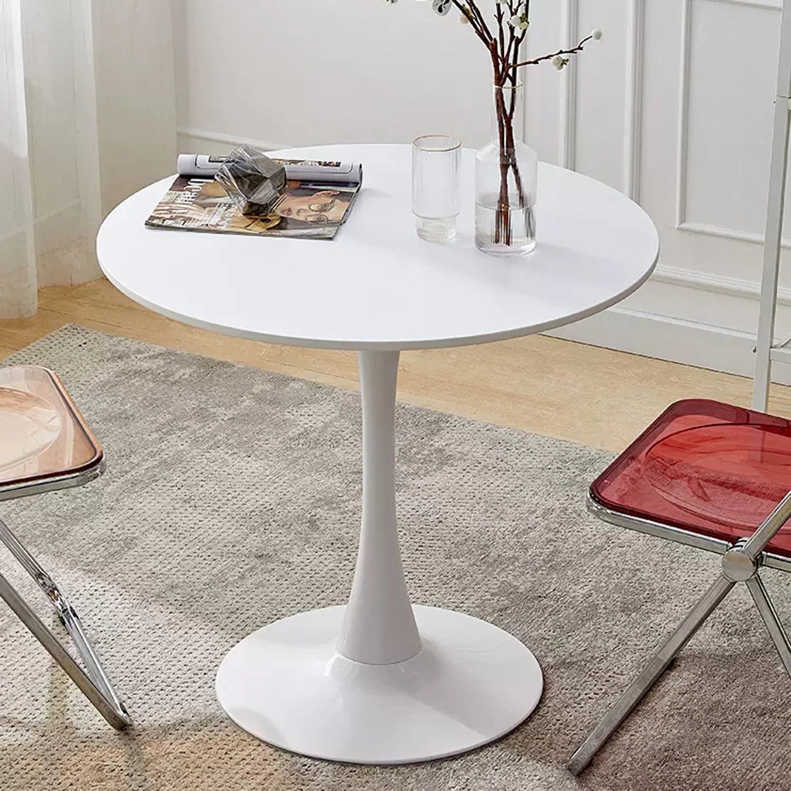 Modern white round dining table with a tulip base and minimalist design