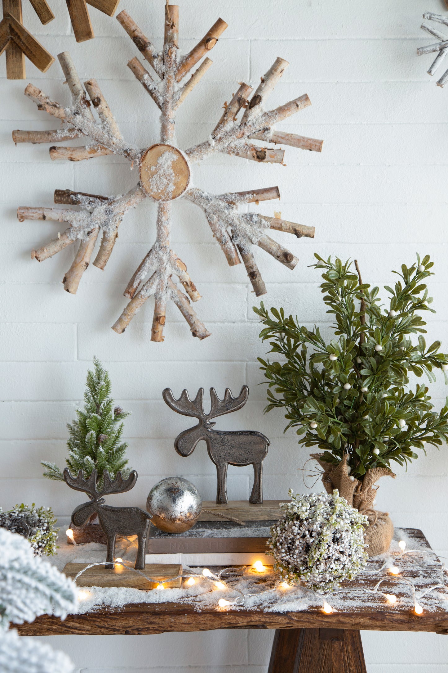 Rustic wooden snowflake decor dusted with faux snow