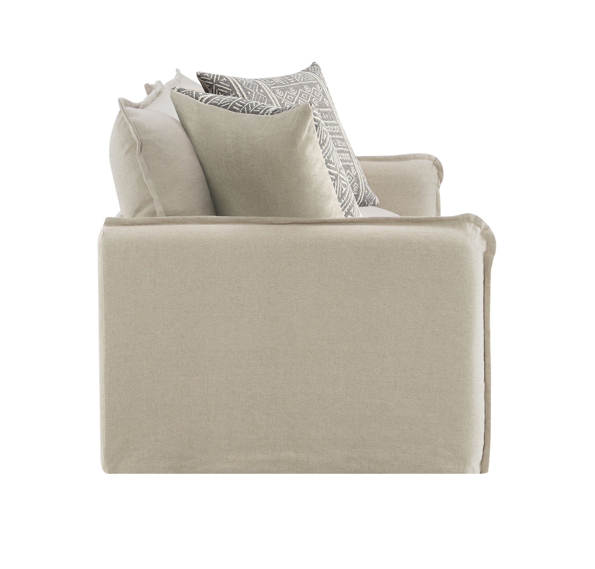 A beige linen armchair with throw pillows