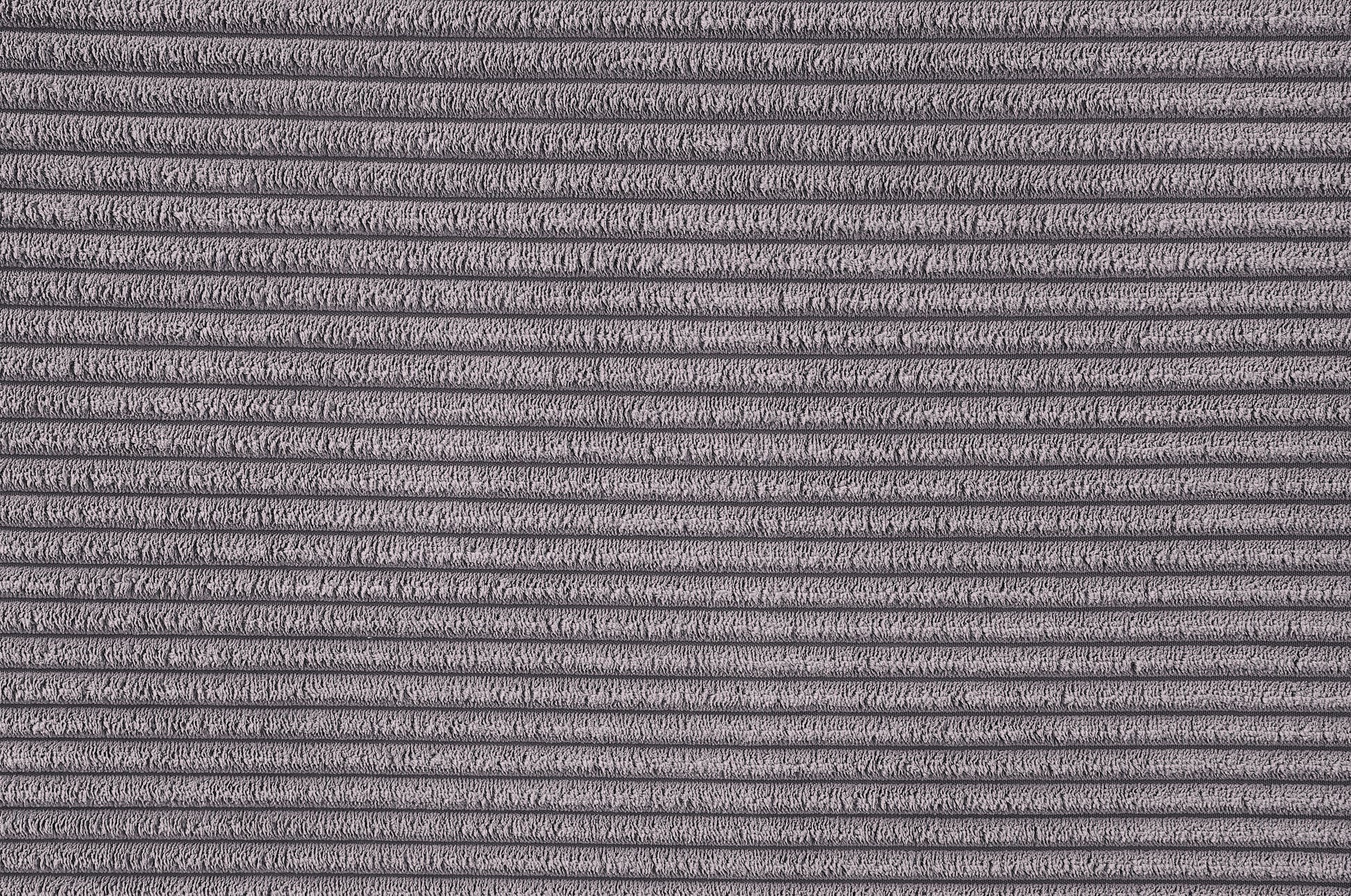 Closeup of thick grey corduroy fabric texture with raised ridges