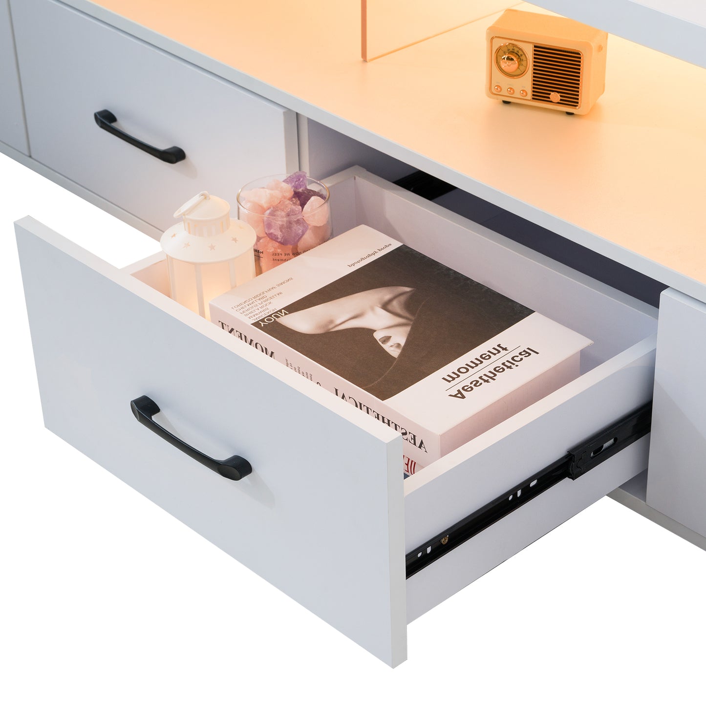 White modern media console drawer with black handle and decorative items
