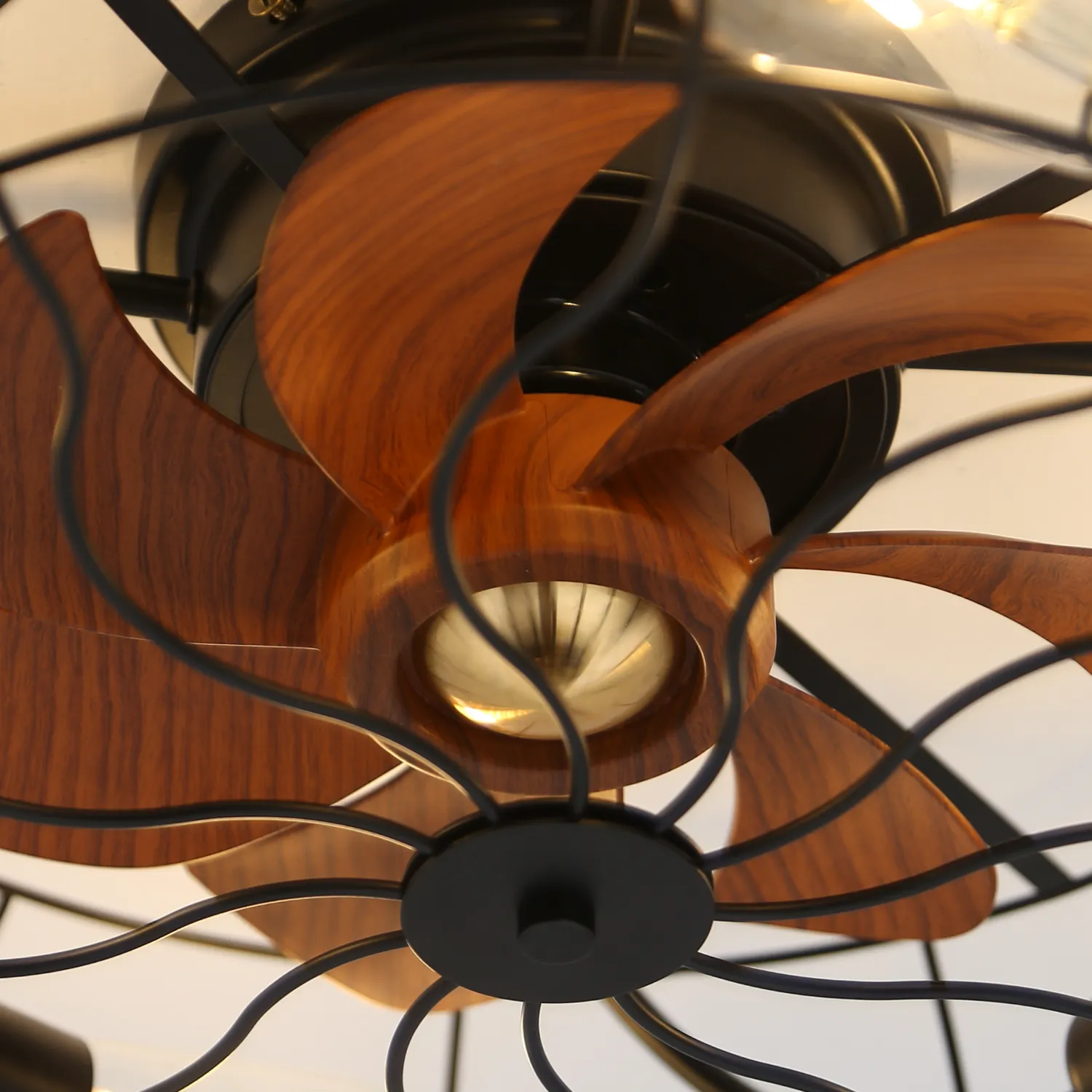 Closeup of vintage wood blade ceiling fan with black cage