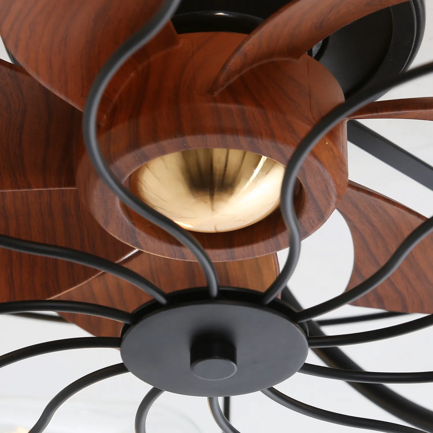 Closeup of a black ceiling fan with woodgrain blades