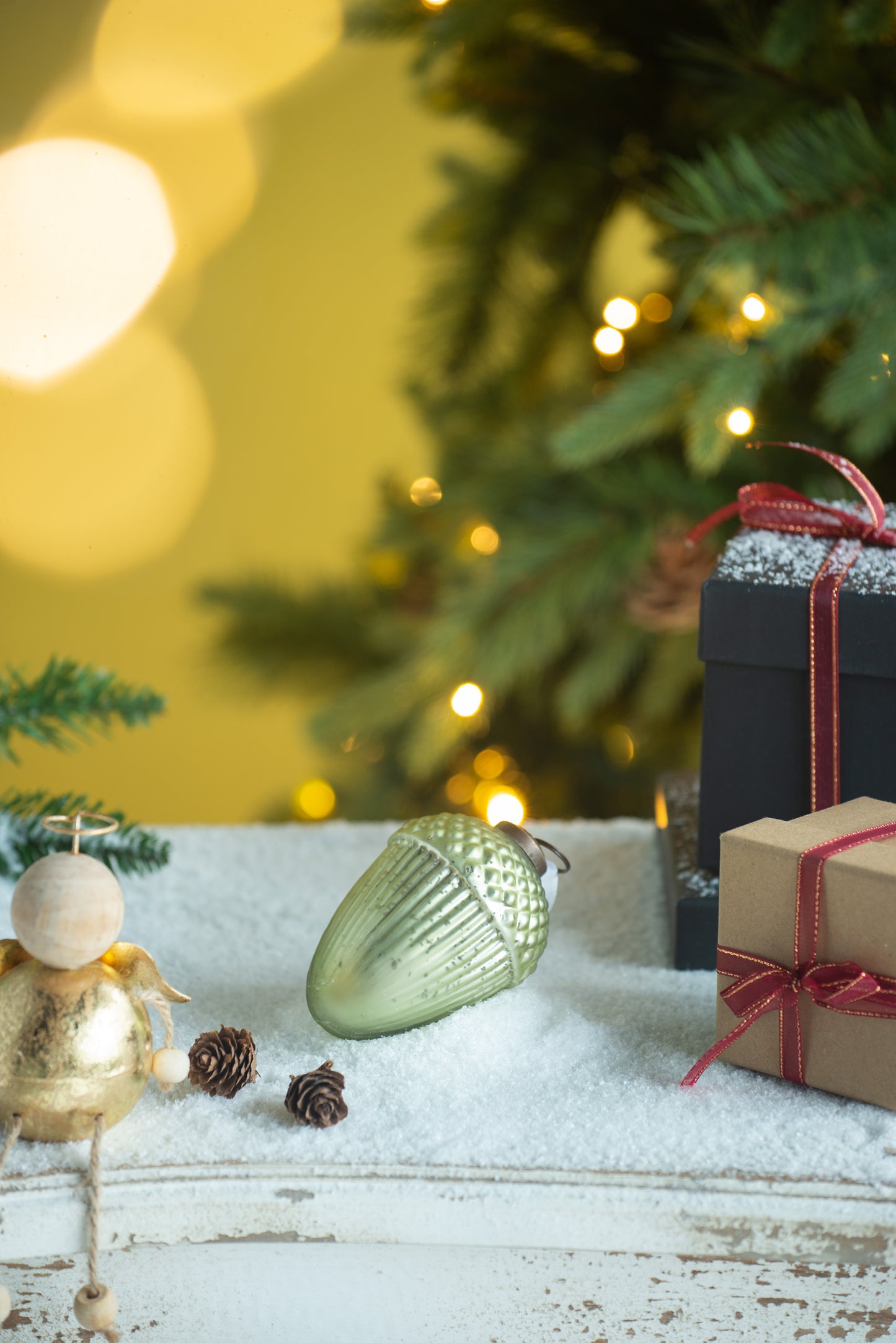 Shimmering pale green glass acorn Christmas ornament with textured cap
