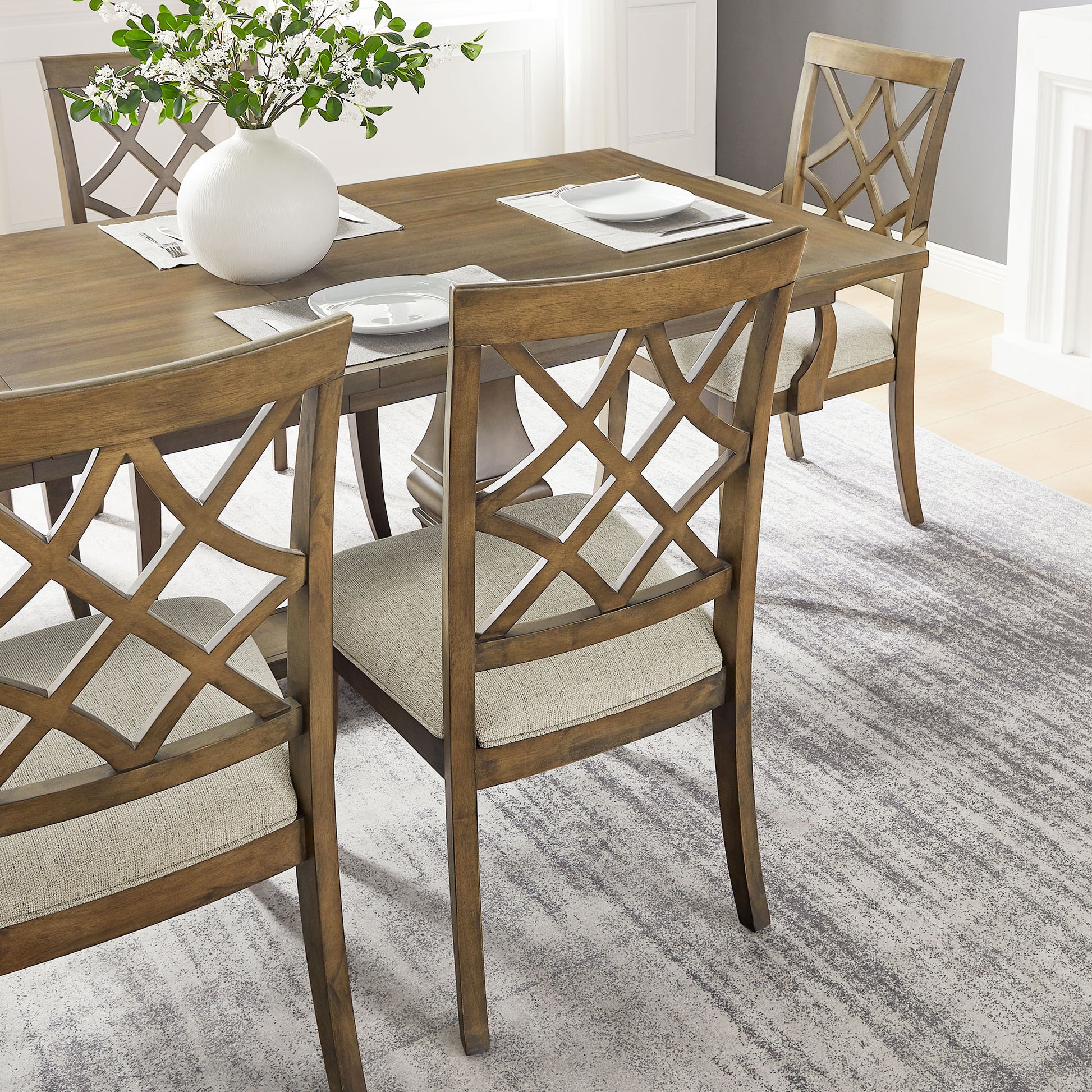 Brown latticeback dining chairs with beige upholstered seats around a wooden table