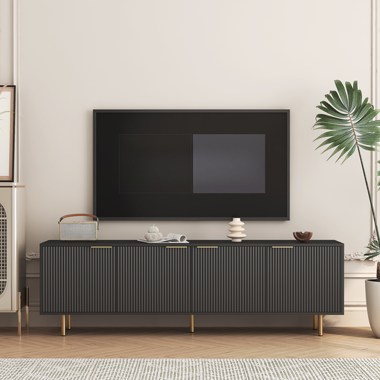 Modern black media console with fluted doors and gold legs