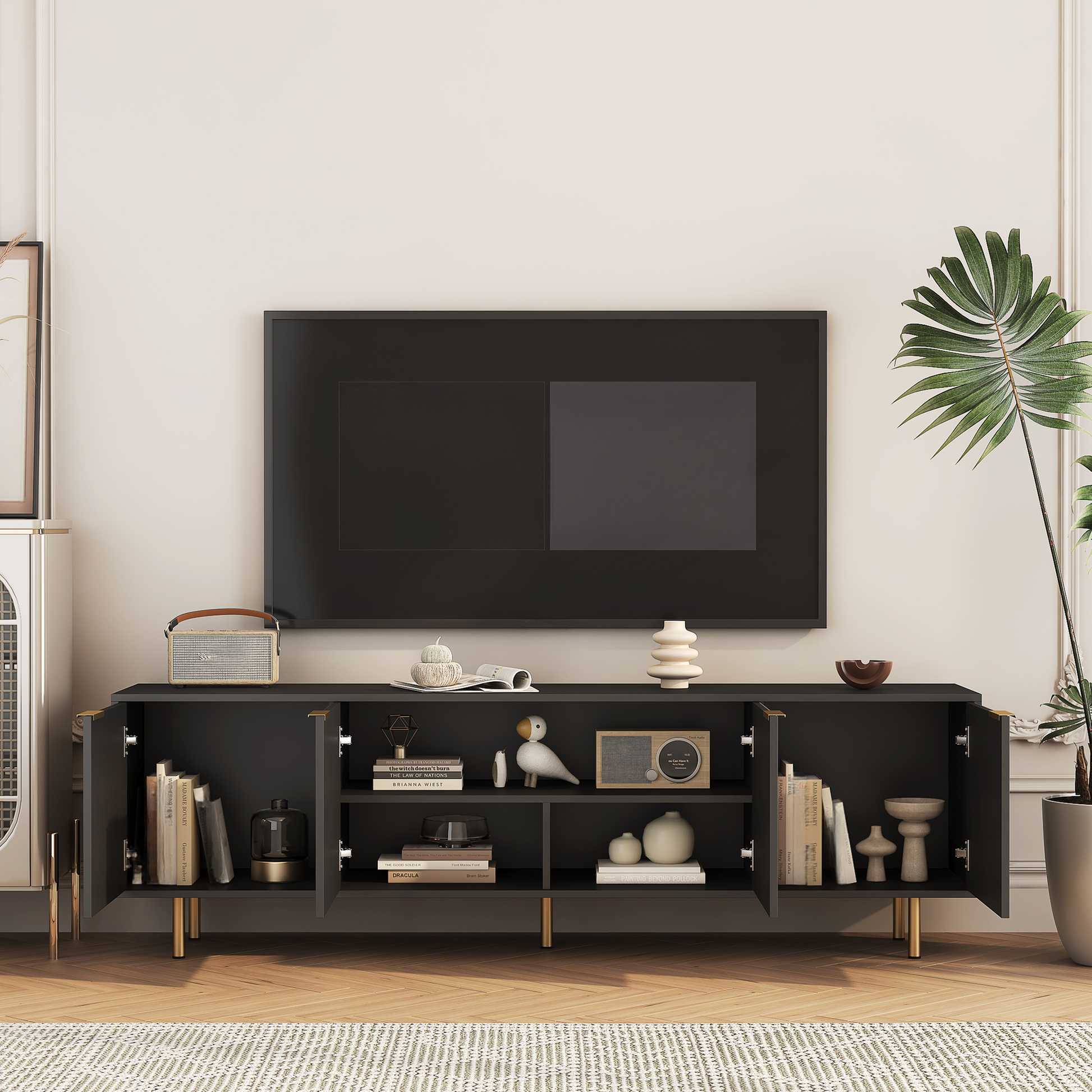 Dark grey modern TV stand with gold accents and open doors showcasing books