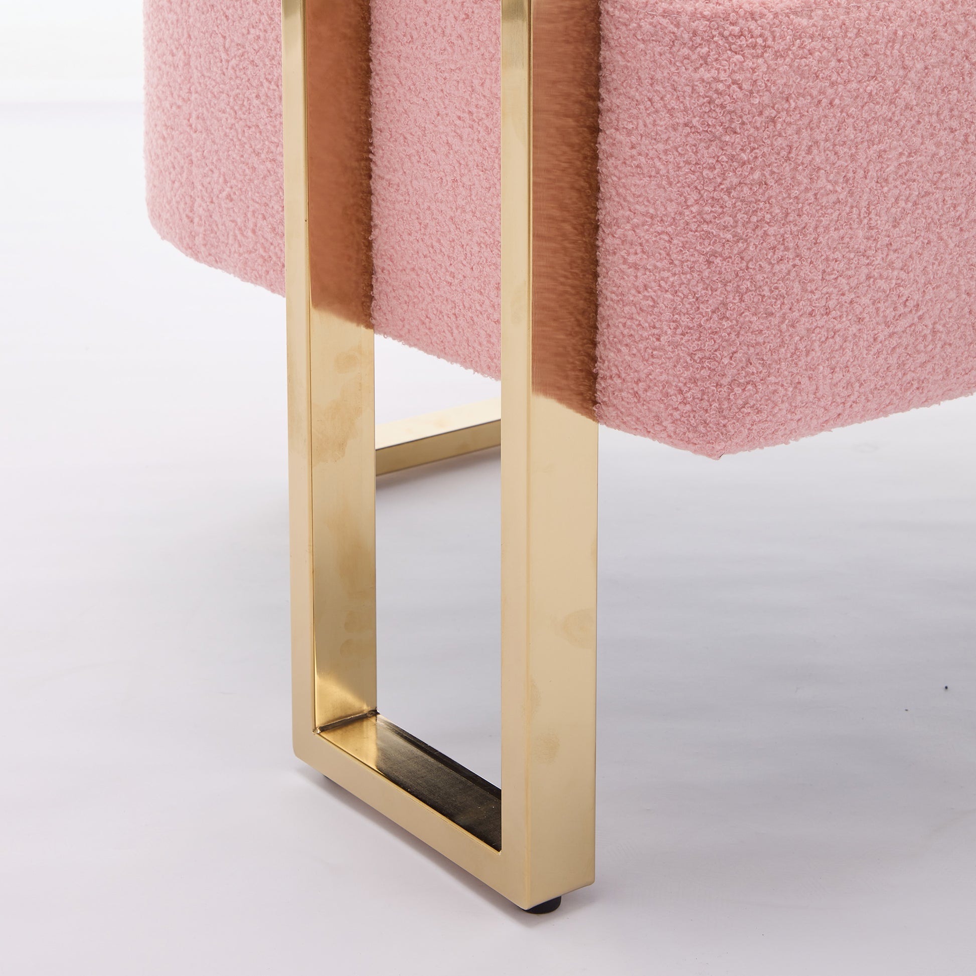Pink boucl ottoman with brushed gold metal frame legs