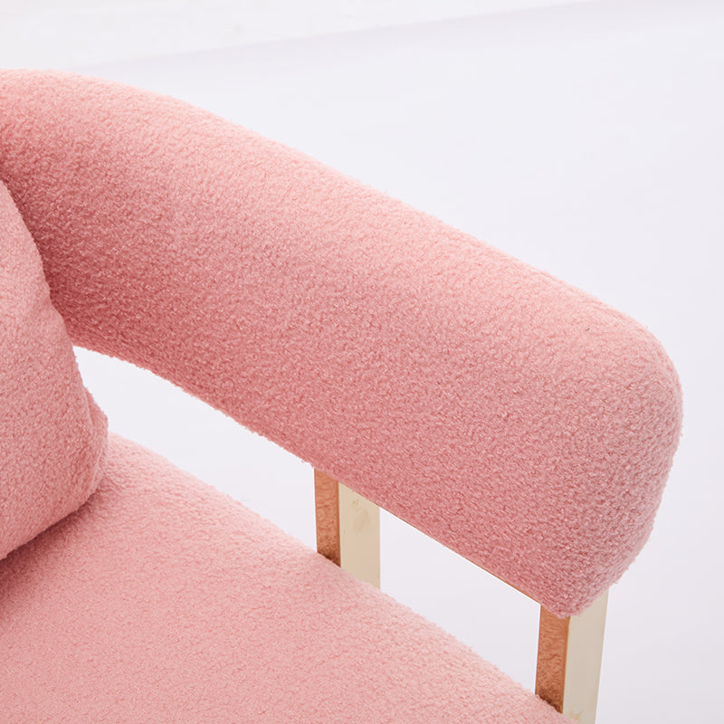 Closeup of a plush pink boucl armchair armrest