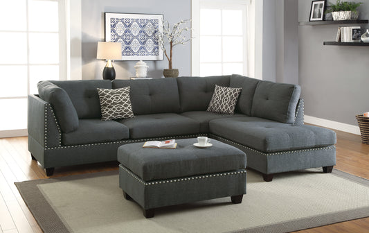 Dark gray fabric sectional sofa with tufted cushions and silver nailhead trim perfect for modern living rooms