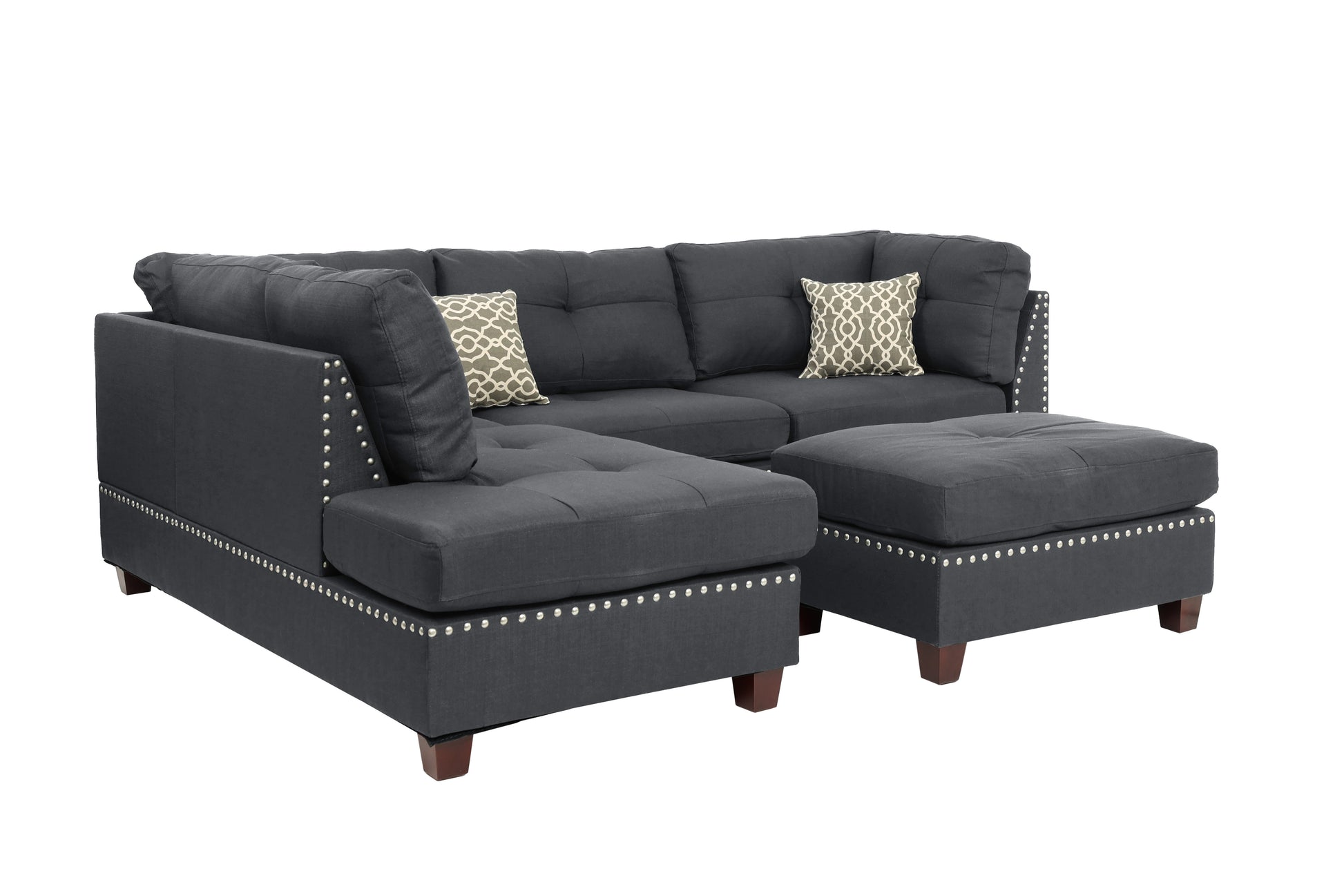 Dark grey tufted sectional sofa with nailhead trim and two decorative pillows