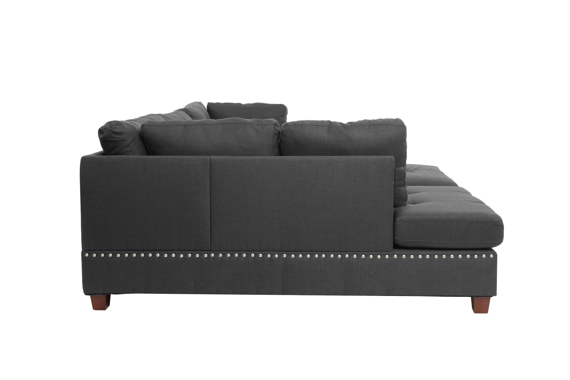 Dark gray fabric sectional sofa with tufted back cushions and silver nailhead trim