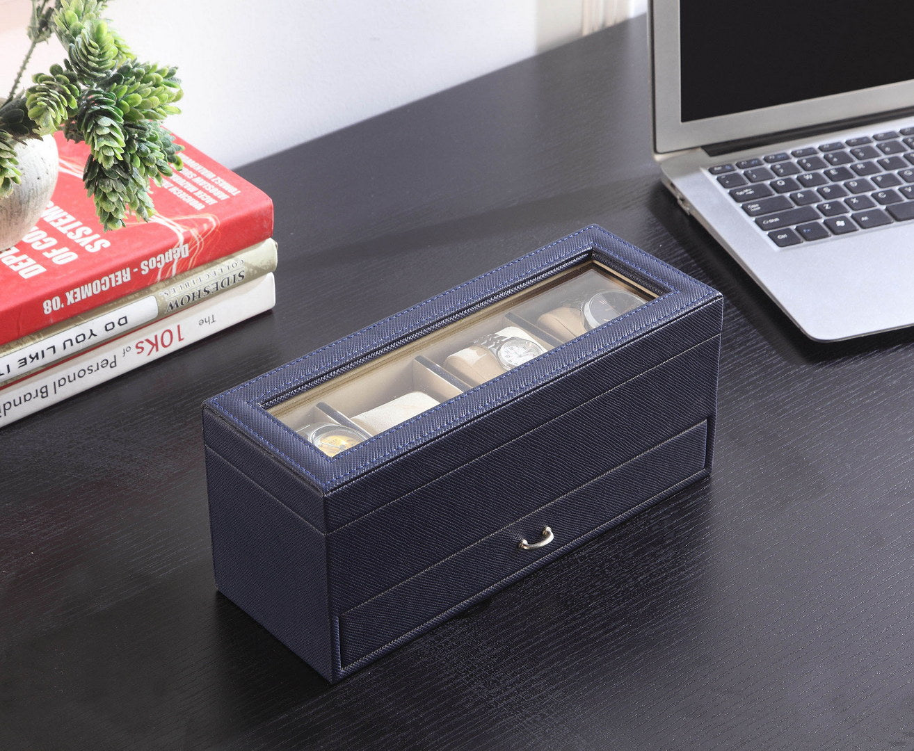 Navy blue leather watch box with glass lid and drawer