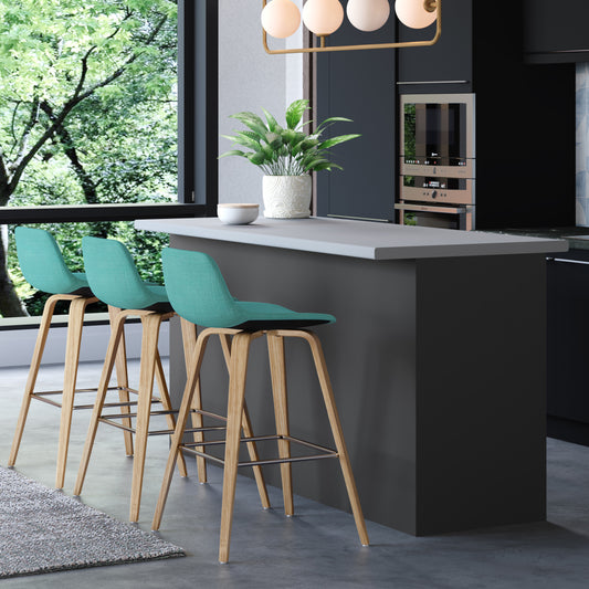 Teal upholstered bar stool with natural wood legs and chrome footrest