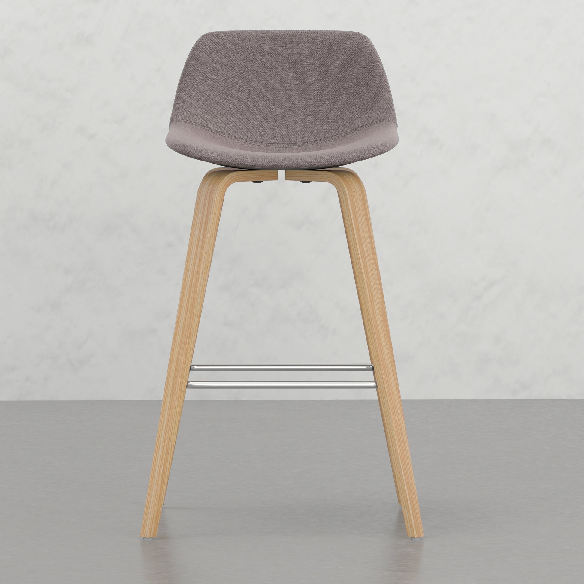 Grey upholstered bar stool with wooden legs and chrome footrest