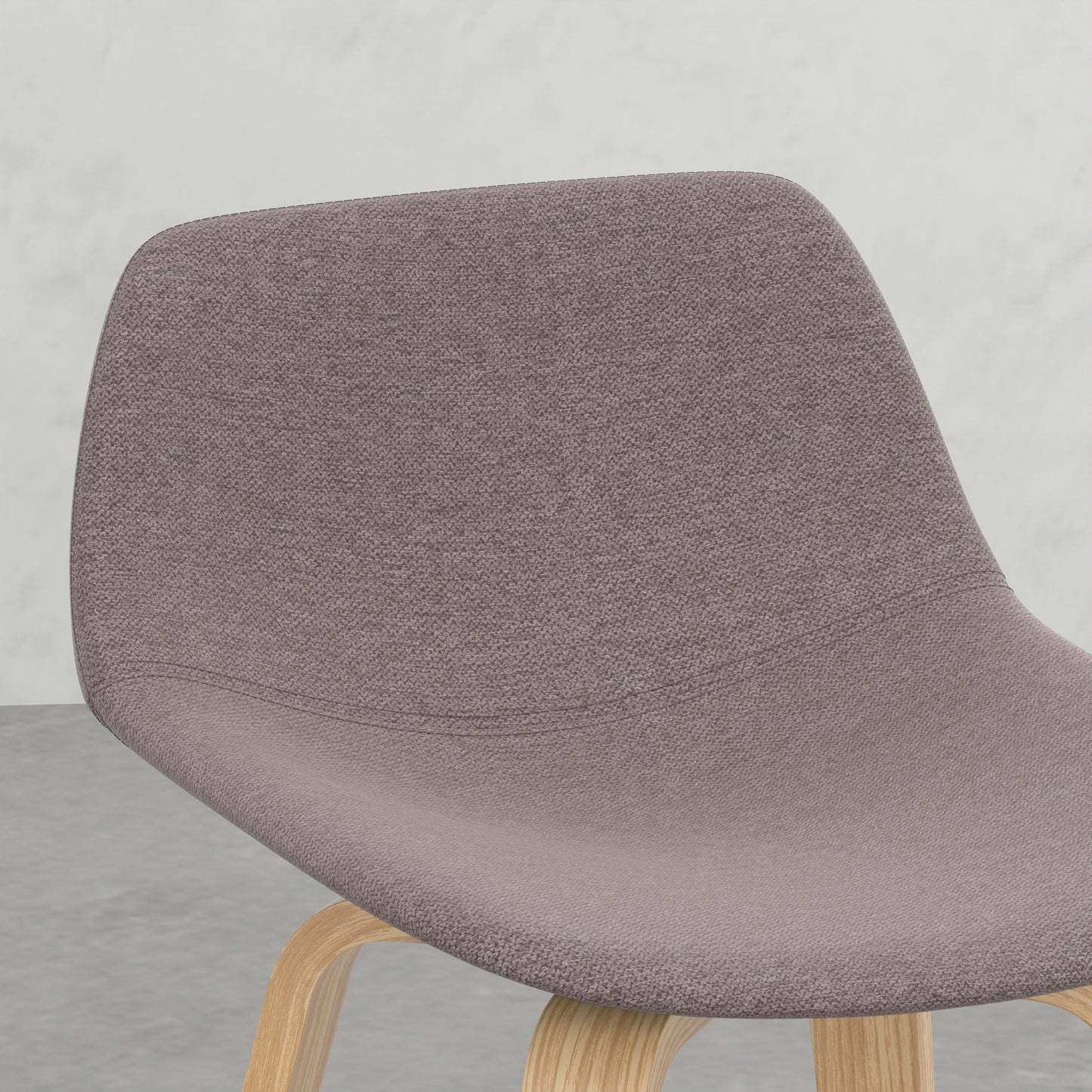 Closeup of a grey upholstered chair seat with visible fabric texture and bentwood legs
