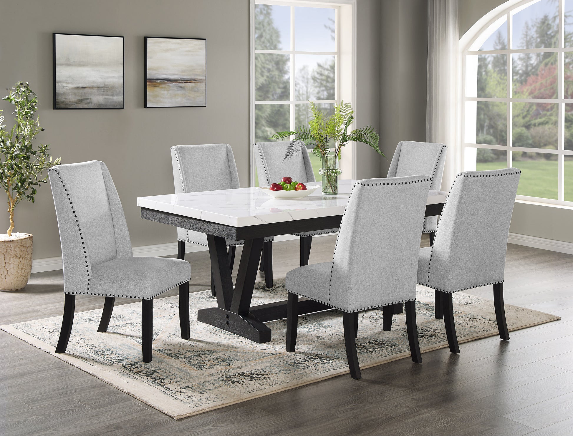Marbletop dining table with dark wood base and grey upholstered chairs
