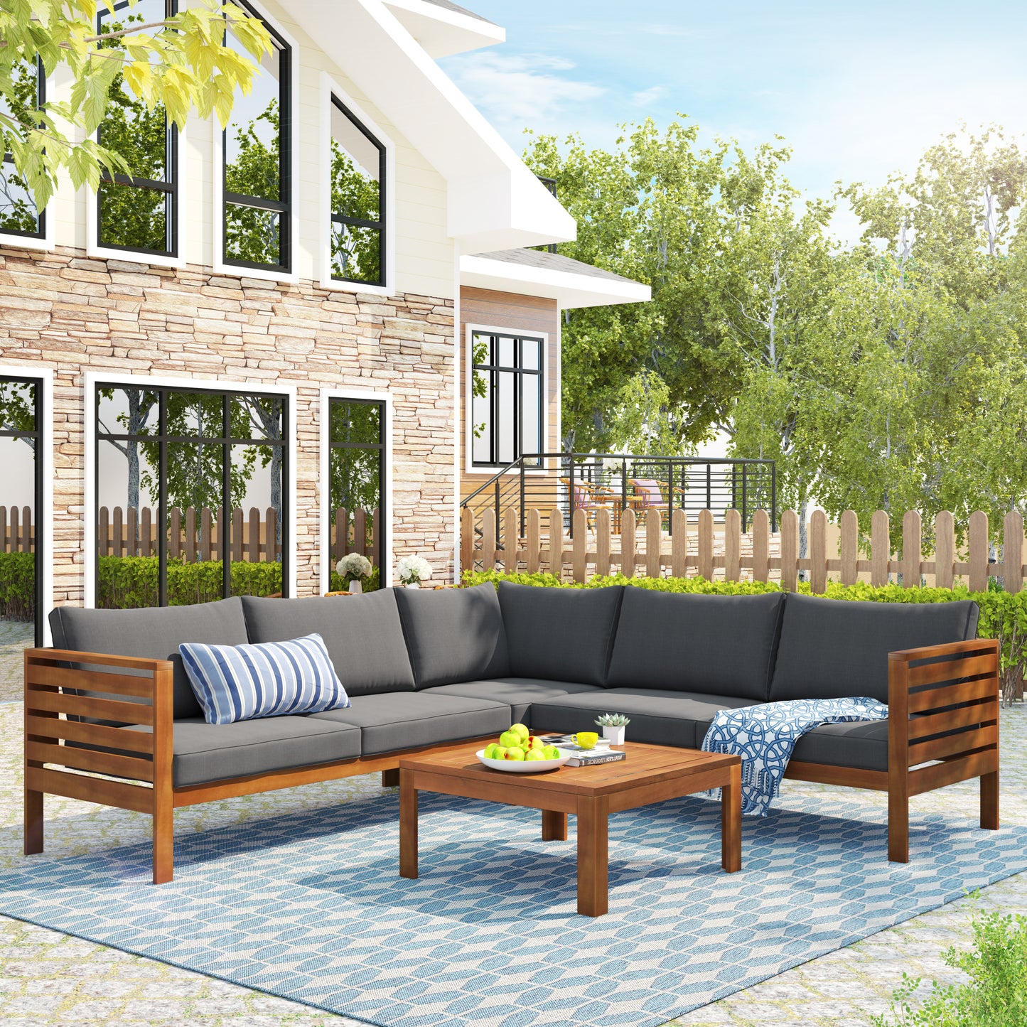 Dark gray sectional patio sofa with wooden frame and blue striped pillow